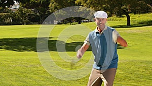 Man celebrating on the putting green of golf course