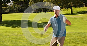 Man celebrating on the putting green of golf course