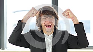 Man Celebrating Success In His Office