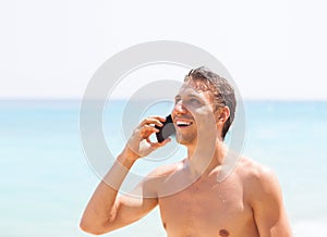 Man cell phone call smile on beach summer vacation