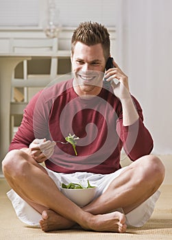 Man With Cell Phone and Salad