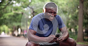 Man, cellphone and headphones for outdoor workout with laughing for funny podcast, humor or fitness. Black person, sweat