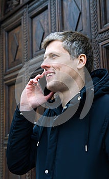 Man with cellphone and smiling