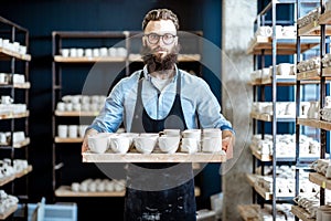 Man with ceramics at the pottery shop