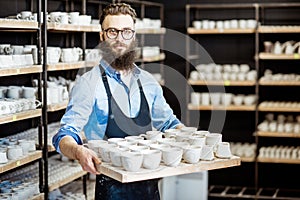 Man with ceramics at the pottery shop