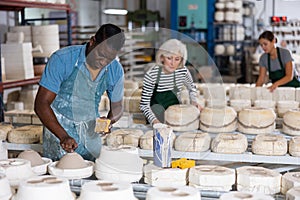 Man ceramist working in pottery workshop