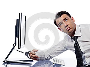 Man chained to computer with handcuffs sad