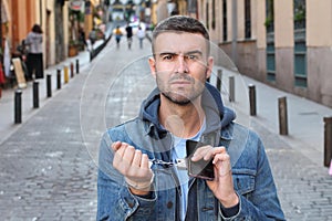 Man chained up to his smartphone addiction concept