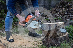 Man Chainsawing Wood in a Garden in Ireland