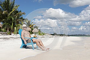 Man in chair on Caribbian beach