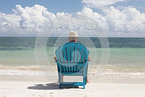 Man in chair on Caribbian beach