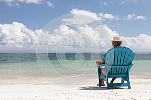 Man in chair on Caribbian beach