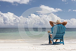 Man in chair on Caribbian beach