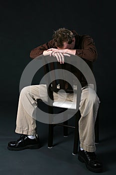 Man in chair with head down