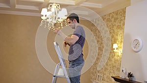 Man changing a burnt out light bulb