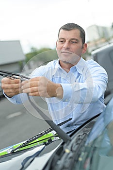 Man changing car wipers