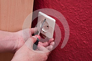 Man changing a electrical outlet