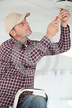 man changing light bulb