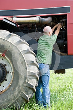 Man changing oil filter on large engine