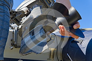 Man changing propeller on outboard motor. Repairing outboard motor for boat, replacing screw.