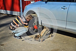 Man changing tires on the car