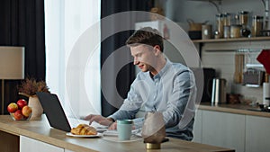 Man chatting friends zoom sitting at kitchen. Guy communicating on video call.