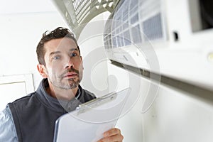 Man checking airconditioning unit