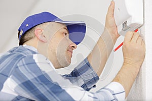 Man checking appearance wall device