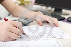 Man is checking balance sheet with pen