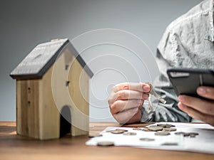 Man checking bills from smart phone and having financial problems with home debt, Money concept., real estate, buy an apartment