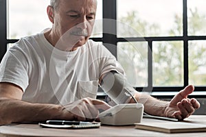 Man checking a blood pressure in the morning