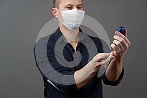 Man checking blood sugar level with glucometer on gray background