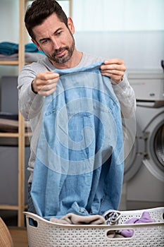 man checking cleanliness laundry