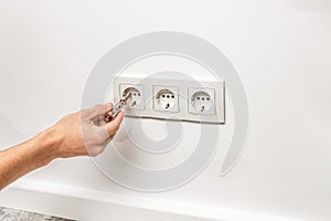Man is checking the electrical outlet