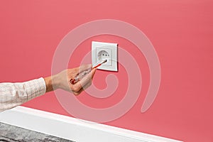 Man is checking the electrical outlet
