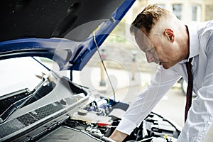 Man checking his broke down car