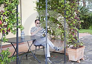 Man checking his mobile phone on a terrace