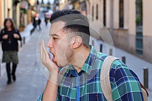 Man checking his own breath