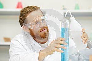 man checking lab liquids