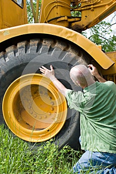 Man checking large tire