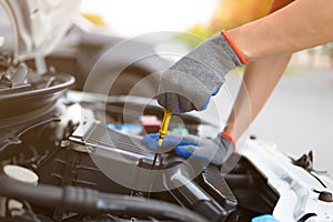 Man checking level of engine oil. Car Repairs, vehicle maintenance, car mechanic, Car inspection and maintenance concept