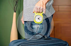 Man checking luggage weight with steelyard balance photo