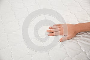Man checking mattress firmness. Space for text photo