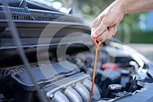 Man checking the oil level in car engine, Check and maintenance the oil level in car with yourself