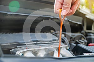 Man checking the oil level in car engine, Check and maintenance the oil level in car with yourself