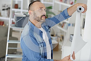 Man checking paper wall