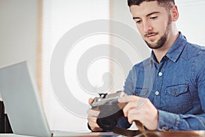 Man checking photographs in camera