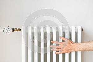 Man checking radiator of the central heating system