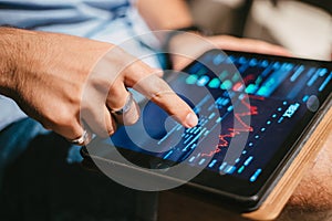 Man checking stock market data on tablet