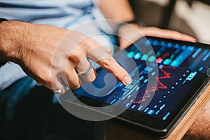 Man checking stock market data on tablet